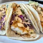 Crispy walleye fish tacos with slaw and creamy sauce
