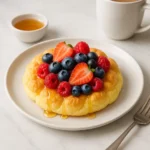 Fluffy cottage cheese cloud bread with berries and honey, angled view
